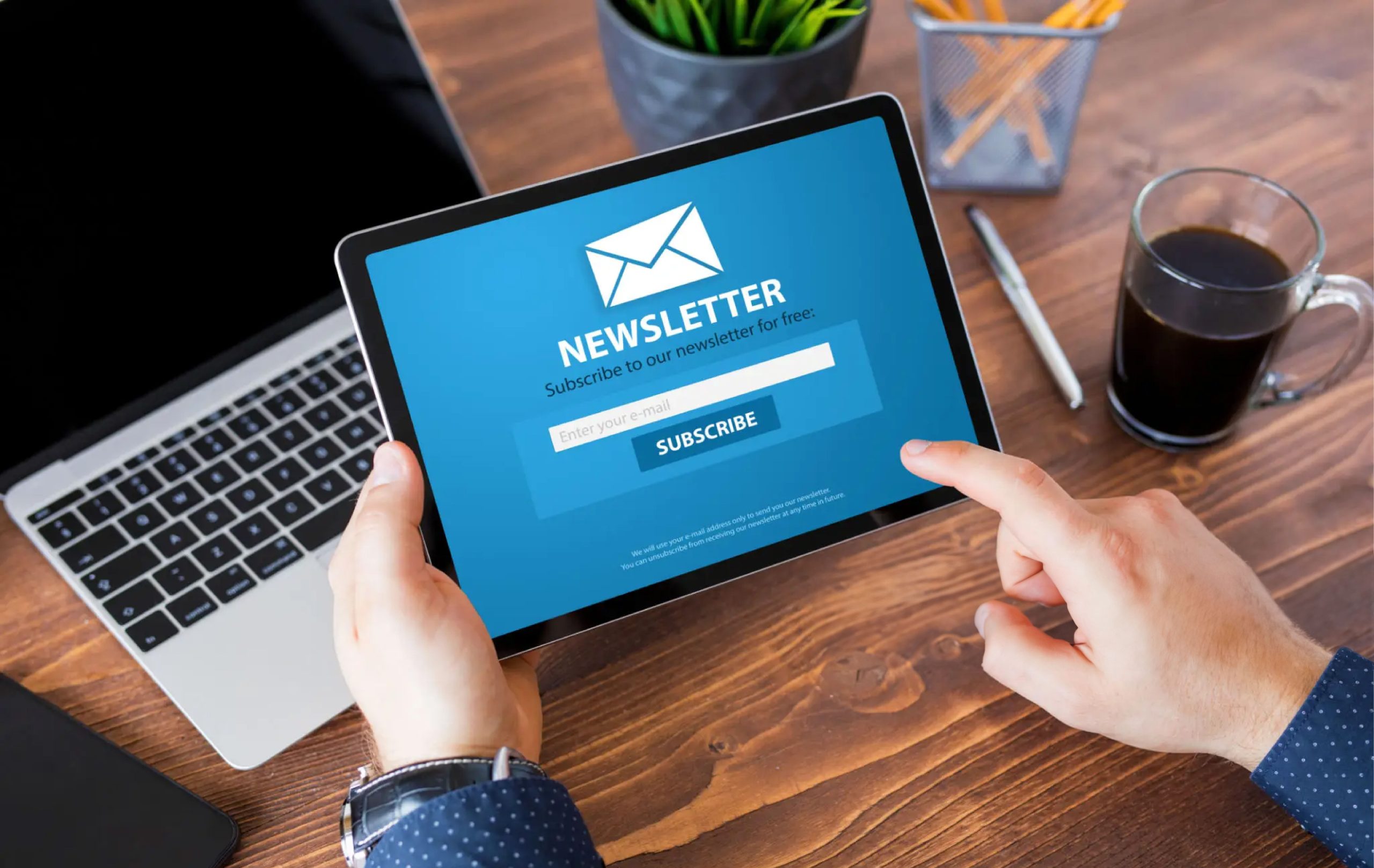 Man reading newsletter signup page on tablet computer | Associated Loggers